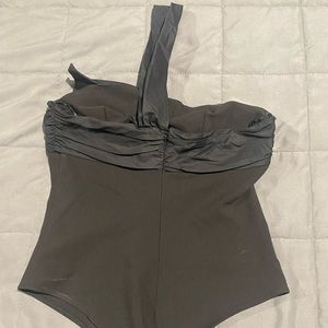 Black sleeveless bodysuit with big bow in front.